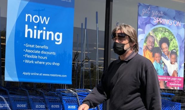 A pedestrian walks by a now hiring sign at Ross Dress For Less store on April 02, 2021 in San Rafae...