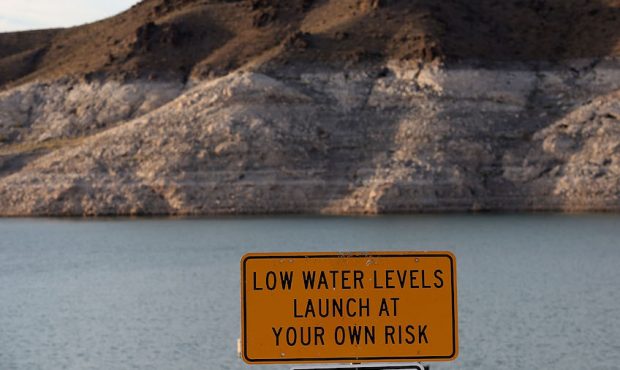 FILE: A sign warning boaters of low water levels is posted near the Echo Bay boat launch on May 12,...
