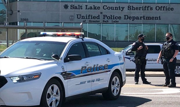 Officers patrol the scene where two deputies with the Salt Lake County Sheriff's Office were injure...