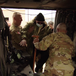 Members of the Utah National Guard help 100-year-old Ken Potts enter a Black Hawk helicopter. (KSL TV)