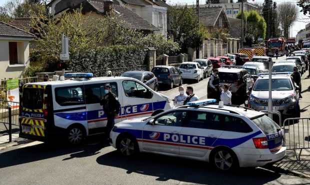 French police officials block off a street near a police station in Rambouillet, south-west of Pari...