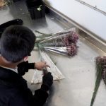 An employee at Esprit Raw Flowers packs up a new shipment. (KSL TV)