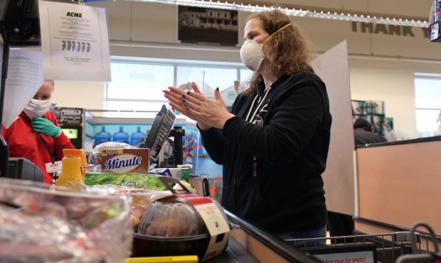 FILE: Clark resident Jen Valencia sanitizes her hands at checkout as she supplements her income wor...