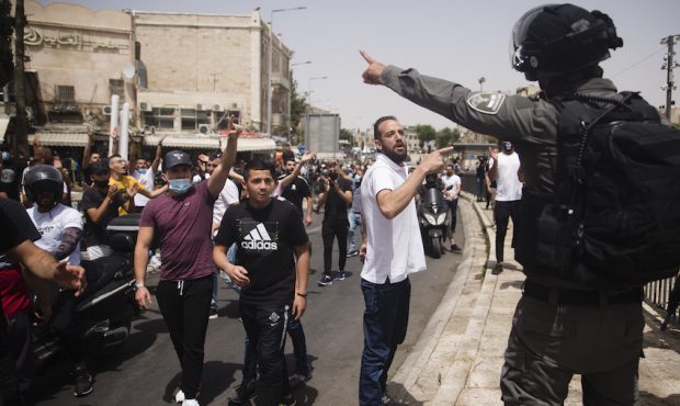 Palestinian men clash with Israeli police officer during a protest near Damascus Gate at Jerusalem'...