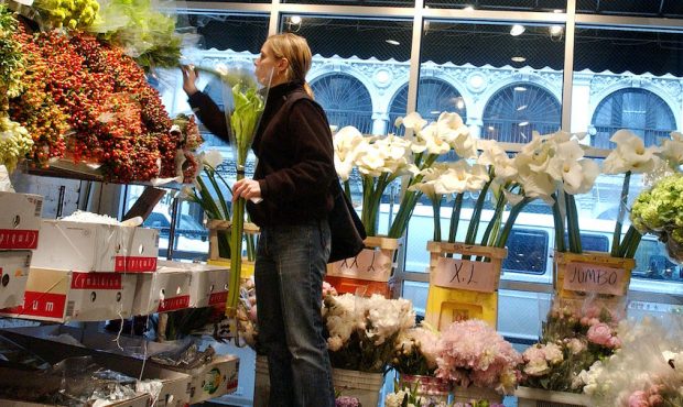 FILE: A women browses through the assortment of flowers in the wholesale flower district in New Yor...