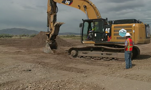 A backhoe starts moving dirt as work begins on the new West Davis Highway. (KSL TV)...