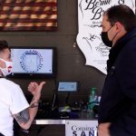 Bernie Hiett, owner of Bernie and Brothers Barber Co., shows KSL’s Matt Gephardt how she takes Bitcoin payments. (KSL TV)