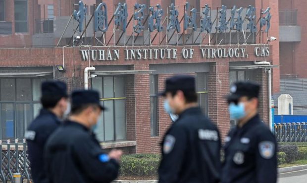 Security personnel stand guard outside the Wuhan Institute of Virology in Wuhan, China in February....