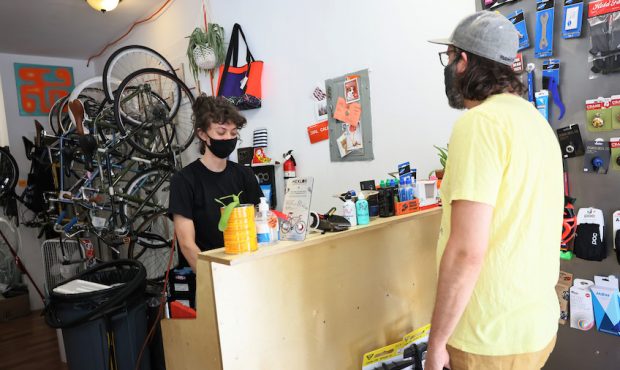 Robin Graven-Milne, owner of Bike Plant, checks out Jeff Laughlin, who is picking up a repaired bik...