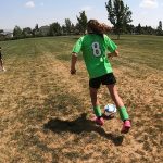 Steve Harris kicks the ball back and forth with his 10-year-old daughter, Sarah Harris. He says coaching allows him to spend time with his kids and play sports which are two of his favorite things. (KSL TV)