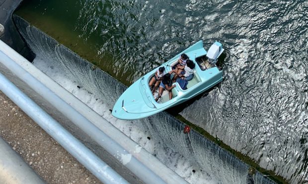 Four people were successfully rescued, after their boat got stuck, dangling over the Longhorn Dam i...