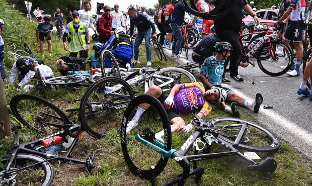 Cyclists Bryan Coquard and Kristian Sbaragli and their teams wait for medical assistance after the ...