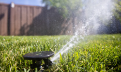 Sprinklers water a lawn in Salt Lake City on Friday, May 7, 2021. Utah Gov. Spencer Cox issues his third water restriction in four months. Spenser Heaps, Deseret News