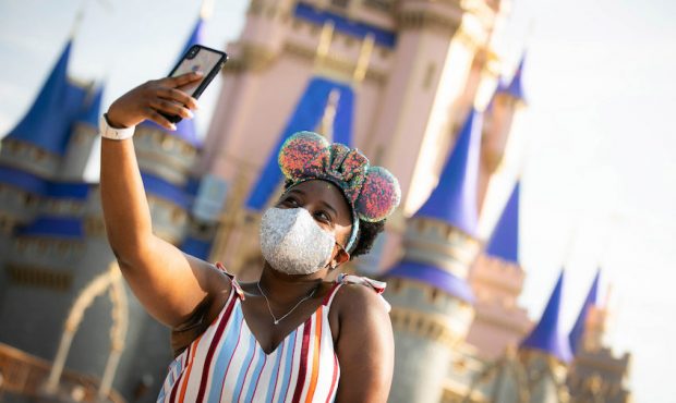 A guest stops to take a selfie at Magic Kingdom Park, July 11, 2020, at Walt Disney World Resort in...