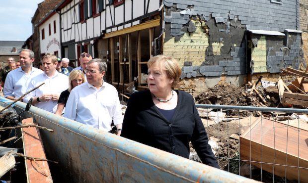 German Chancellor Angela Merkel (R) and Prime Minister of North Rhine-Westphalia Armin Laschet (C) ...