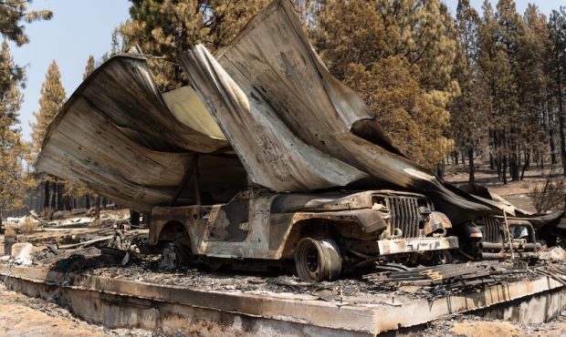 The remnants of a garage burnt down by the Bootleg Fire lay on a residential property on July 22, 2...