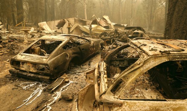 Burned out cars sit in front of a home that was destroyed by the Dixie Fire on July 26, 2021 in Ind...
