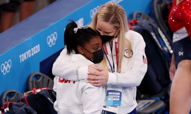 Simone Biles of Team United States is embraced by coach Cecile Landi during the Women's Team Final ...