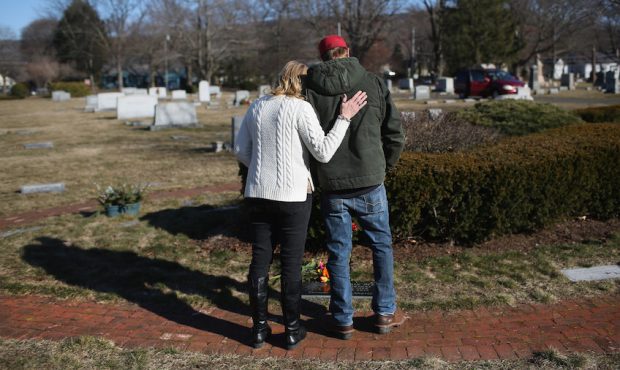 FILE: Family members embrace in a cemetery on March 6, 2016 in Plantsville, Connecticut to commemor...