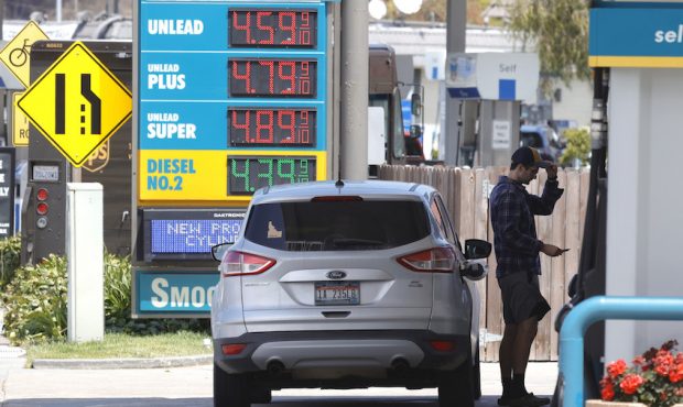 FILE: A customer prepares to pump gasoline into his car at a Valero station on July 12, 2021 in Mil...