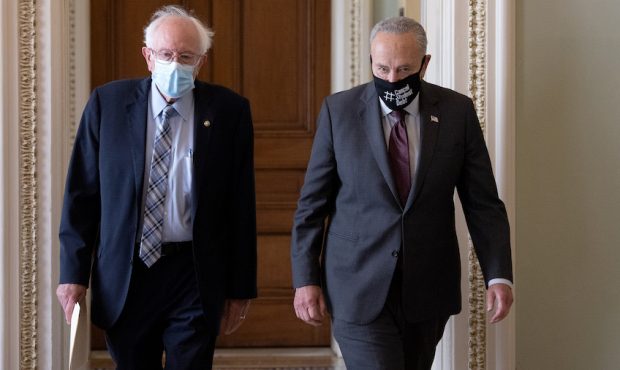 Sen. Bernie Sanders (L) (I-VT) walks with Senate Majority Leader Chuck Schumer (D-NY) after meeting...