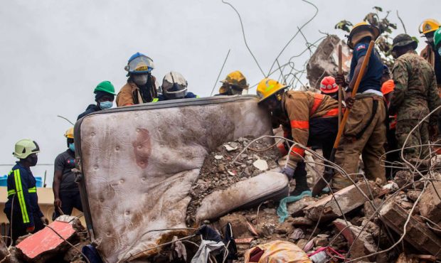 Firefighters remove debris in search of survivors after a 7.2-magnitude earthquake struck Haiti and...