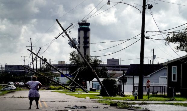 A woman looks over damage to a neighborhood caused by Hurricane Ida on August 30, 2021 in Kenner, L...