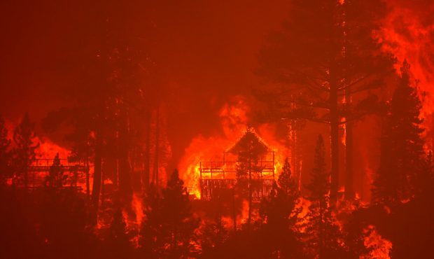 The Caldor Fire burns homes along a ridge on Aug. 30, 2021, near South Lake Tahoe, California. The ...