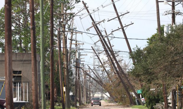 Utility poles lean over a street following Hurricane Ida on August 31, 2021 in Houma, Louisiana. Id...