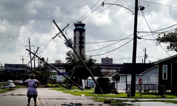 A woman looks over damage to a neighborhood caused by Hurricane Ida on August 30, 2021 in Kenner, L...