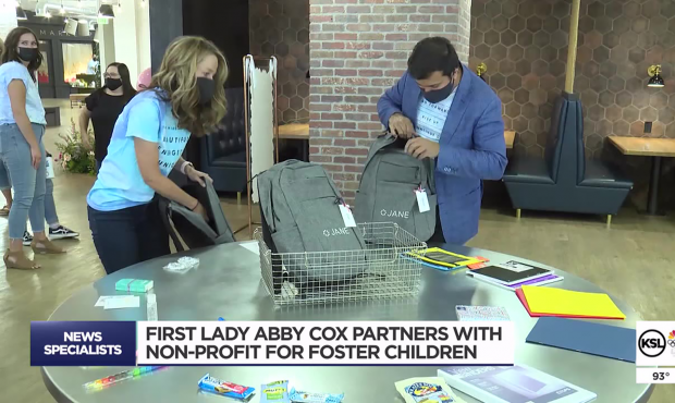 First Lady Abby Cox helps fill backpacks for foster children....