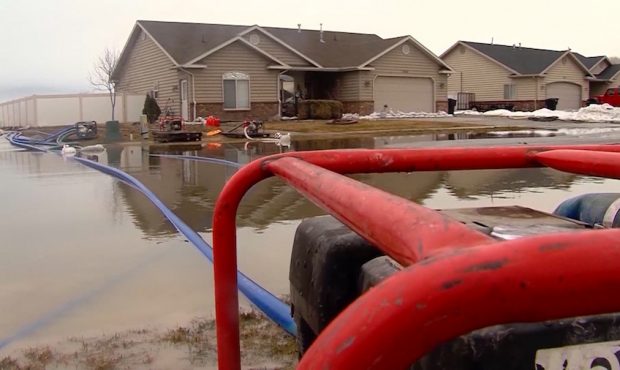 Water is pumped out from a basement after it was flooded. (KSL-TV)...