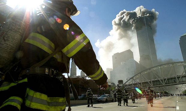 Firefighters walk towards one of the tower at the World Trade Center before it collapsed after a pl...