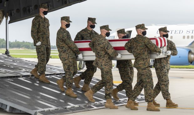 A U.S. Marine Corps carry team transfers the remains of Marine Corps Staff Sgt. Darin T. Hoover of ...