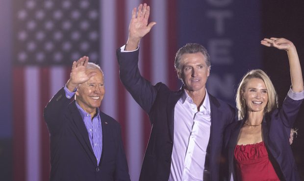 President Joe Biden, California Gov. Gavin Newsom and Jennifer Lynn Siebel Newsom wave to the crowd...