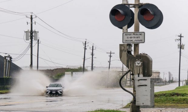 A car speeds through a flooded street ahead of the Tropical Storm Nicholas on September 13, 2021 in...