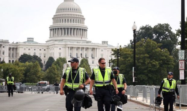 WASHINGTON, DC - SEPTEMBER 18: U.S. Capitol Police officers walk near the scene of the 'Justice for...