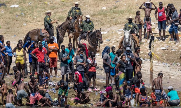 CIUDAD ACUNA, MEXICO - SEPTEMBER 20: Mounted U.S. Border Patrol agents watch Haitian immigrants on ...
