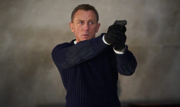 James Bond (Daniel Craig) prepares to shoot in NO TIME TO DIE, an EON Productions and Metro-Goldwyn...