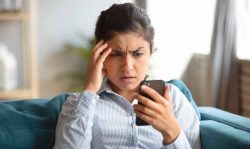 Frustrated girl feels stressed with cellphone problems