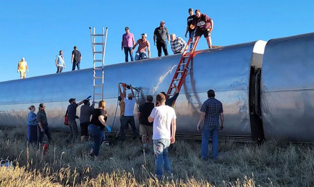 In this photo provided by Kimberly Fossen, people work at the scene of an Amtrak train derailment o...