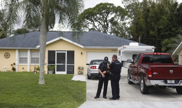 FILE: North Port Police officers stands in the driveway of Brian Laundrie, who is a person of inter...