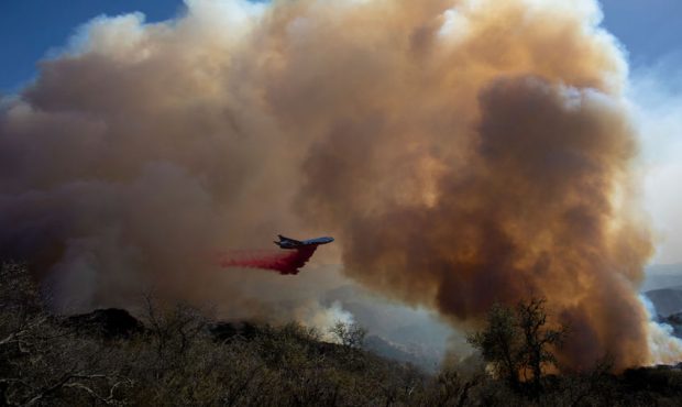A firefighting jet drops fire retardant as the Alisal Fire burns on October 13, 2021 near Goleta, C...