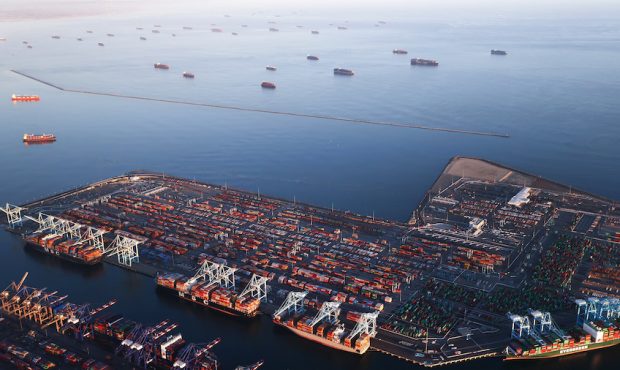 In an aerial view, container ships are anchored by the ports of Long Beach and Los Angeles as they ...