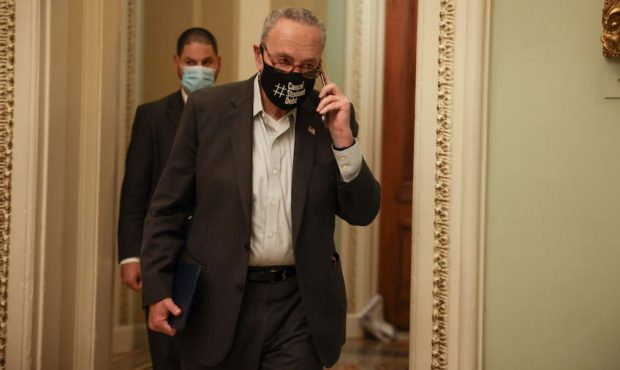 Senate Majority Leader Chuck Schumer (D-NY) speaks on the phone as he arrives on Capitol Hill on Oc...