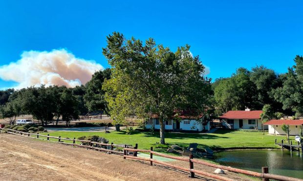 A smoke column builds in the distance behind Rancho del Cielo in Santa Barbara County. (Mike Eliaso...