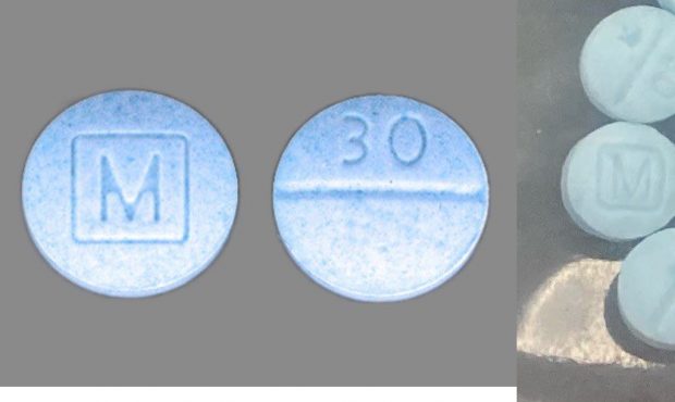 Oxycodone pills side by side with fake fentanyl photos made to look like the powerful pain killer b...