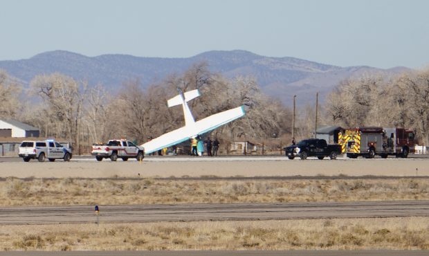 A small plane is seen nose down after it crashed in Cedar City....