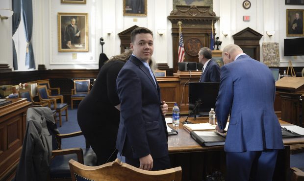 Kyle Rittenhouse, center, makes his way to his seat at the beginning of the day at the Kenosha Coun...