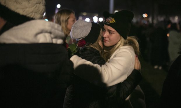 People embrace one another during a vigil in Cutler Park on November 22, 2021 in Waukesha, Wisconsi...